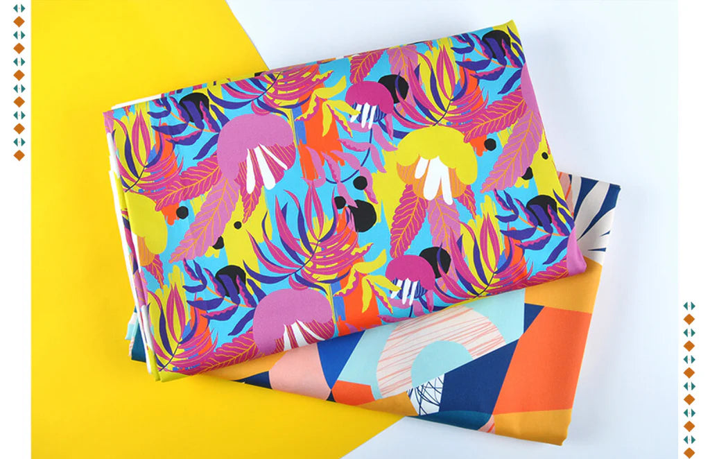 a woman wearing a flowy dress and a fabric waving in the air